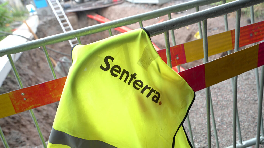 Senterra - Väst med Senterras logotyp över ett räcke på en arbetspalts